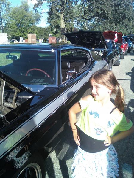 Melhoney, my grand daughter, posing in front of my car at the Berkley CruiseFest.  August 17,  2012.