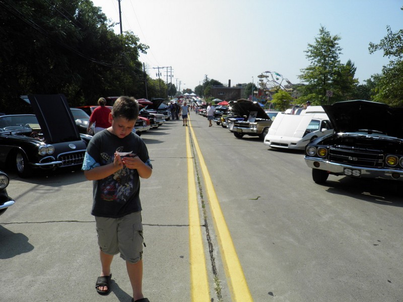 P8290484
My son Jacob was enjoying all the cars.  Right here he is deciding who to vote on.