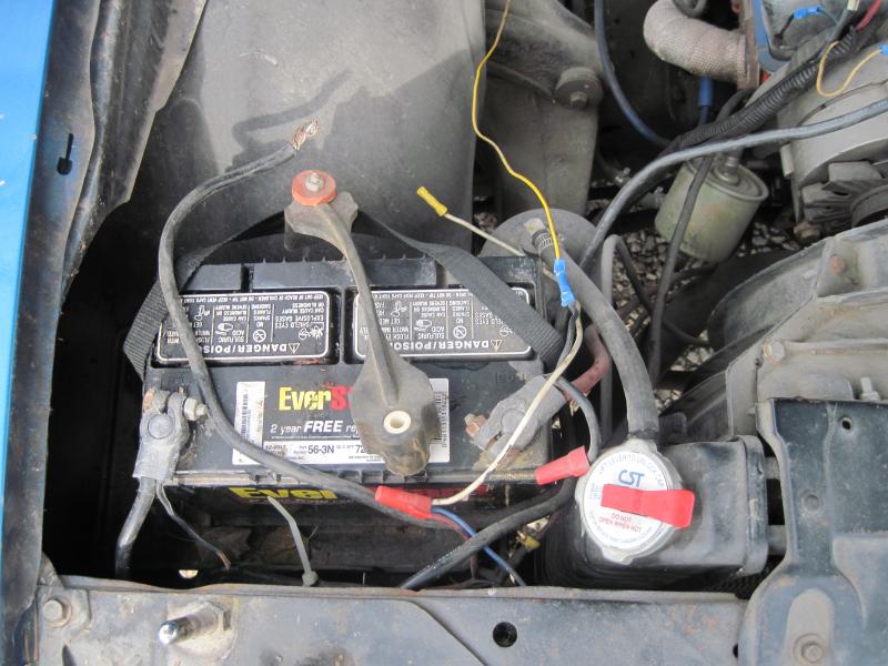The large gauge wire in top leads behind the alternator but is attached to nothing at all